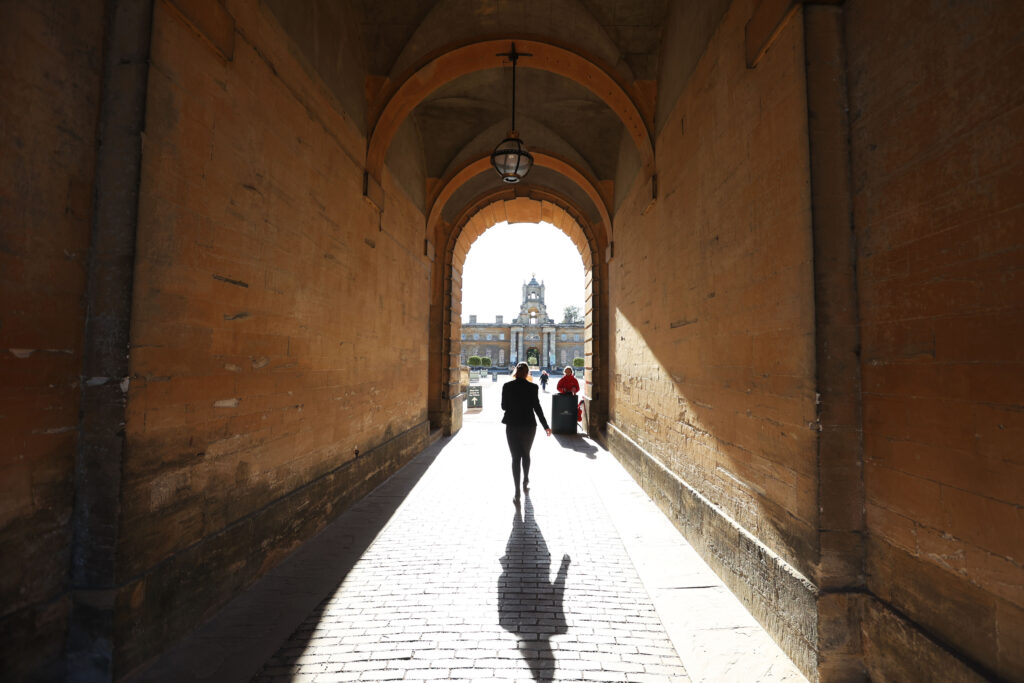 Person walking through an arch at Blenheim Palace